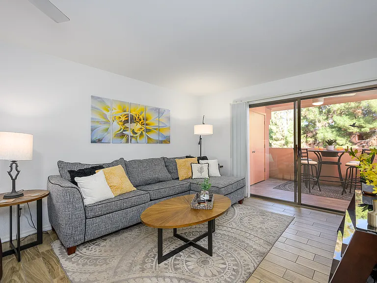 Living room has leather recliner and large sofa bed couch with chaise for four.