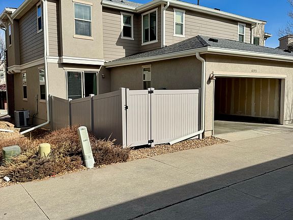 Back view with garage and backyard