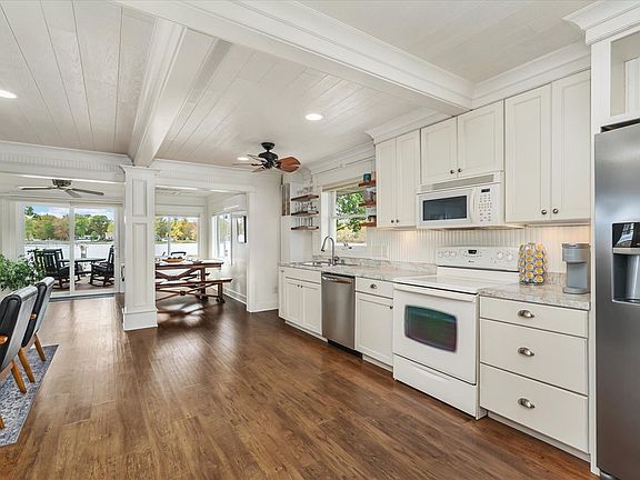 Enjoy the convenience of updated appliances_including a dishwasher, a rare find in classic lakefront cottages. Modern touches meet timeless charm for a stay that's as functional as it is cozy.