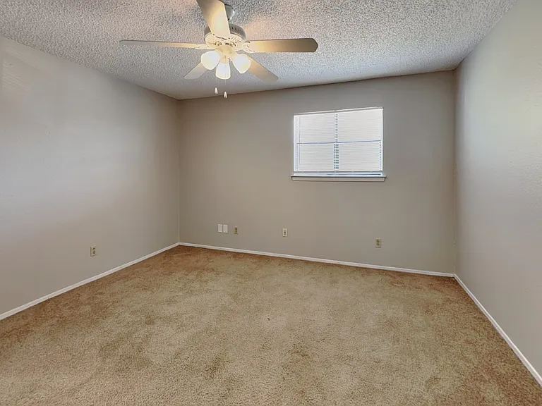 Spacious bedroom with neutral