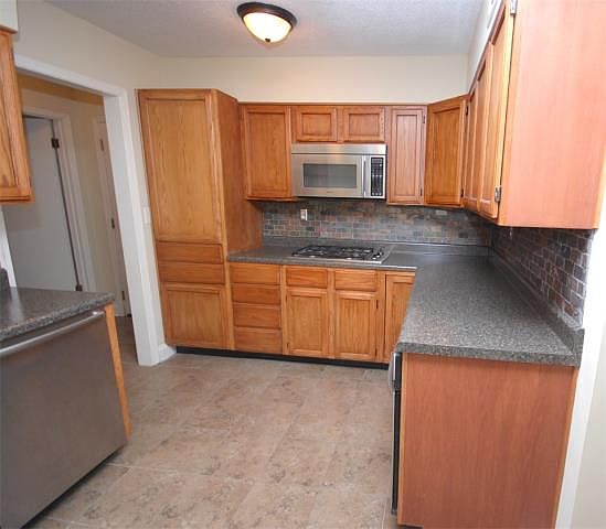 Beautiful kitchen with hardwood cabinets and plenty of countertop space.