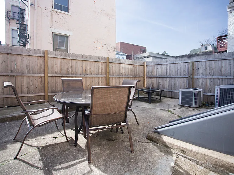 Patio in rear of building, shared with other unit.
