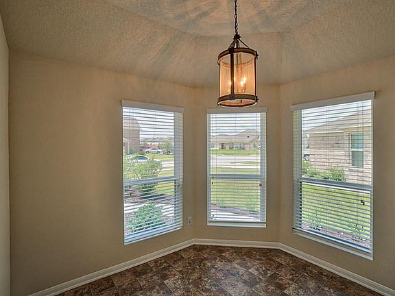 Charming breakfast nook has garage door access and tons of natural lighting!