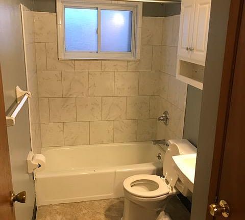 Bathroom with ceramic tile tub surround.