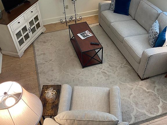 Spacious den with ceiling fan and coat closet 
Close to 1/2 bath, laundry room, kitchen, & dining area.