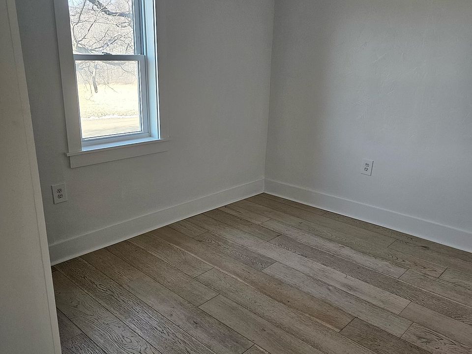 One bedroom with closet and new flooring.