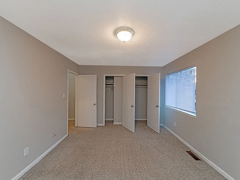 Cozy bedroom with carpet & overhead lighting