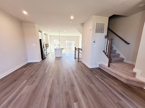 Living room looking towards the kitchen. Check out the warm wide plank floors!