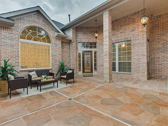 Enter through the Iron Gate onto the the quaint Courtyard with Flagstone Decking and a covered walkway to the adorable Casita located just inside the Front Gate.