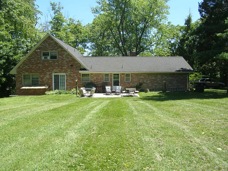 Basement entrance is on the left of the back of the house.