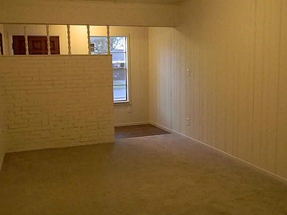   Formal dining room has clean, neutral paint and carpet along with ceiling fan.