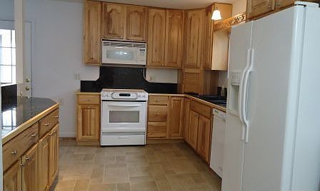 Granite countertops, hickory cabinets, KitchenAid stove, microwave, dishwasher