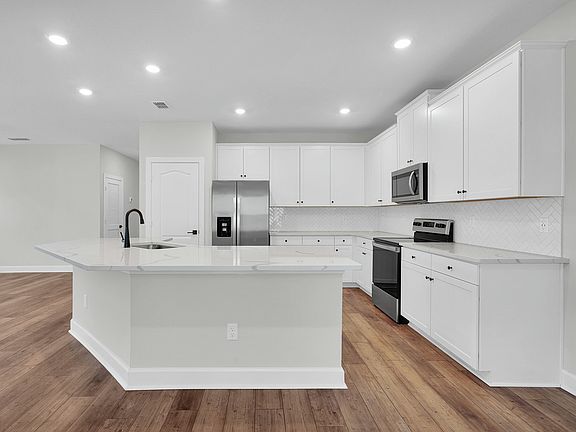 The kitchen comes chef-ready with stainless steel appliances
