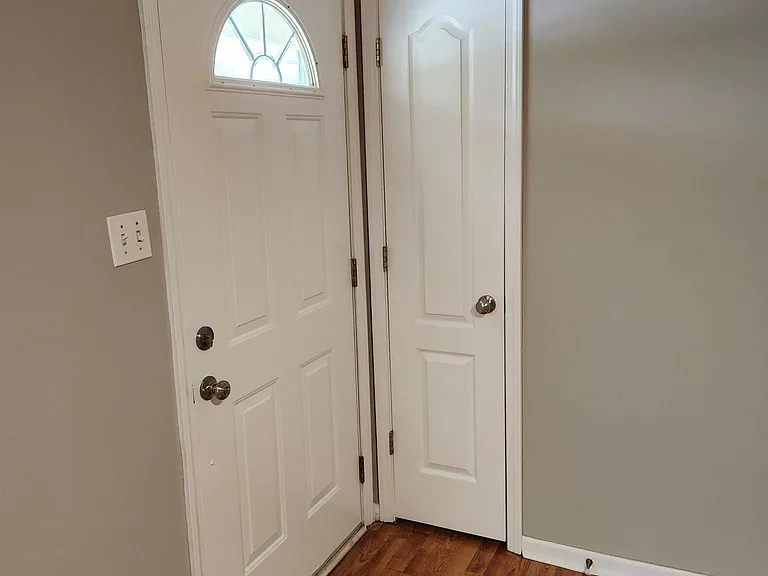 Front door entrance from Living Room view; lots of sunlight; coat closet