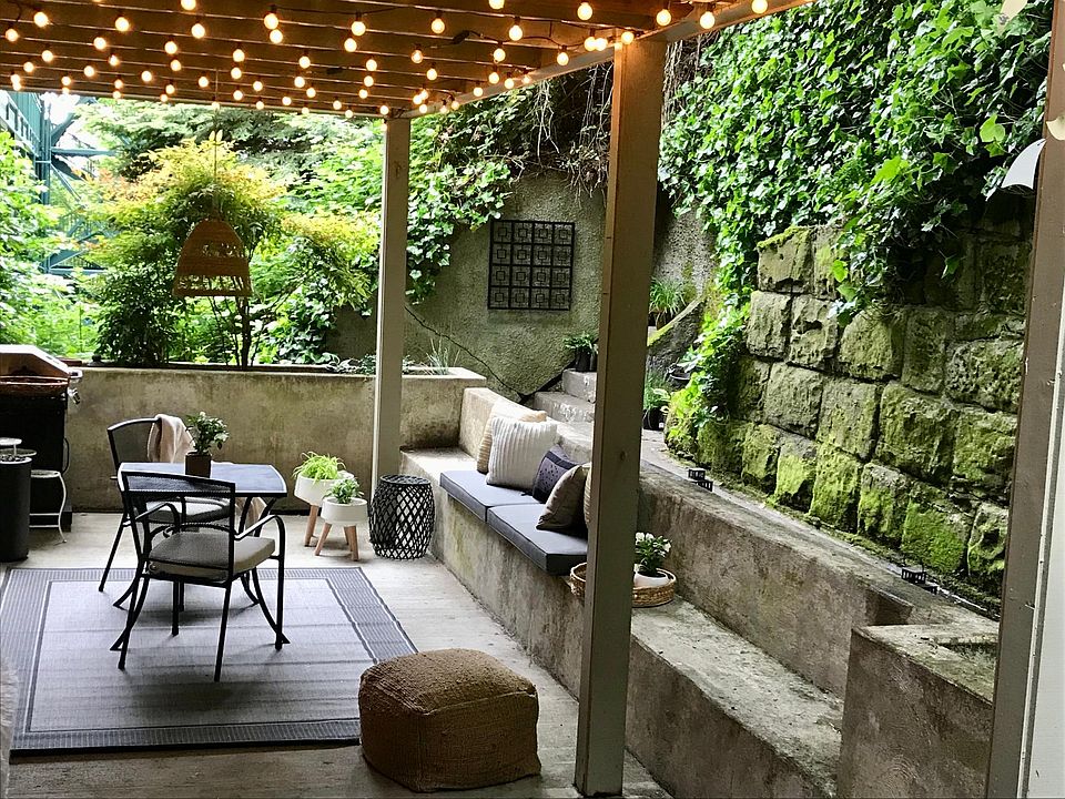 A rare, oversized private patio space in the city with raised garden beds and built-in seating. A dreamy setting!