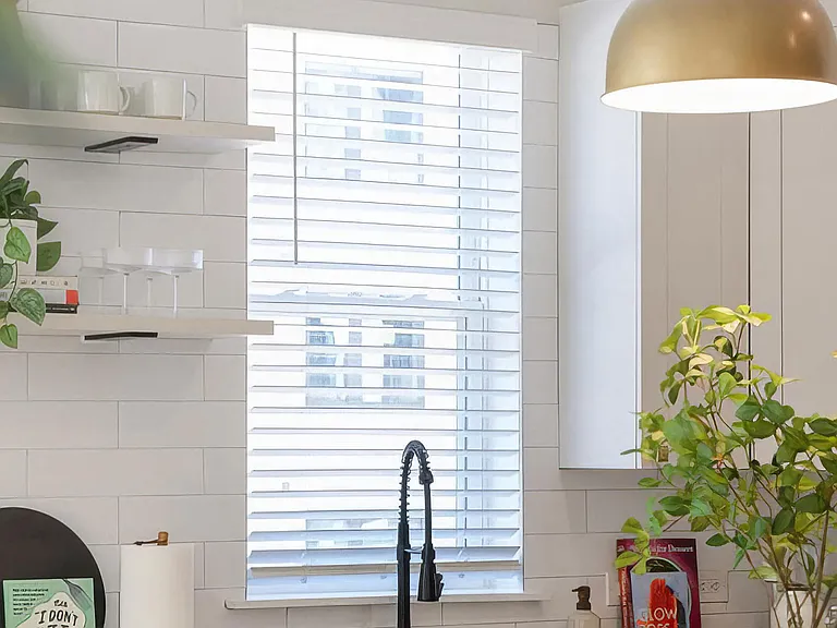 Clean kitchen with stainless steel appliances and modern shelving