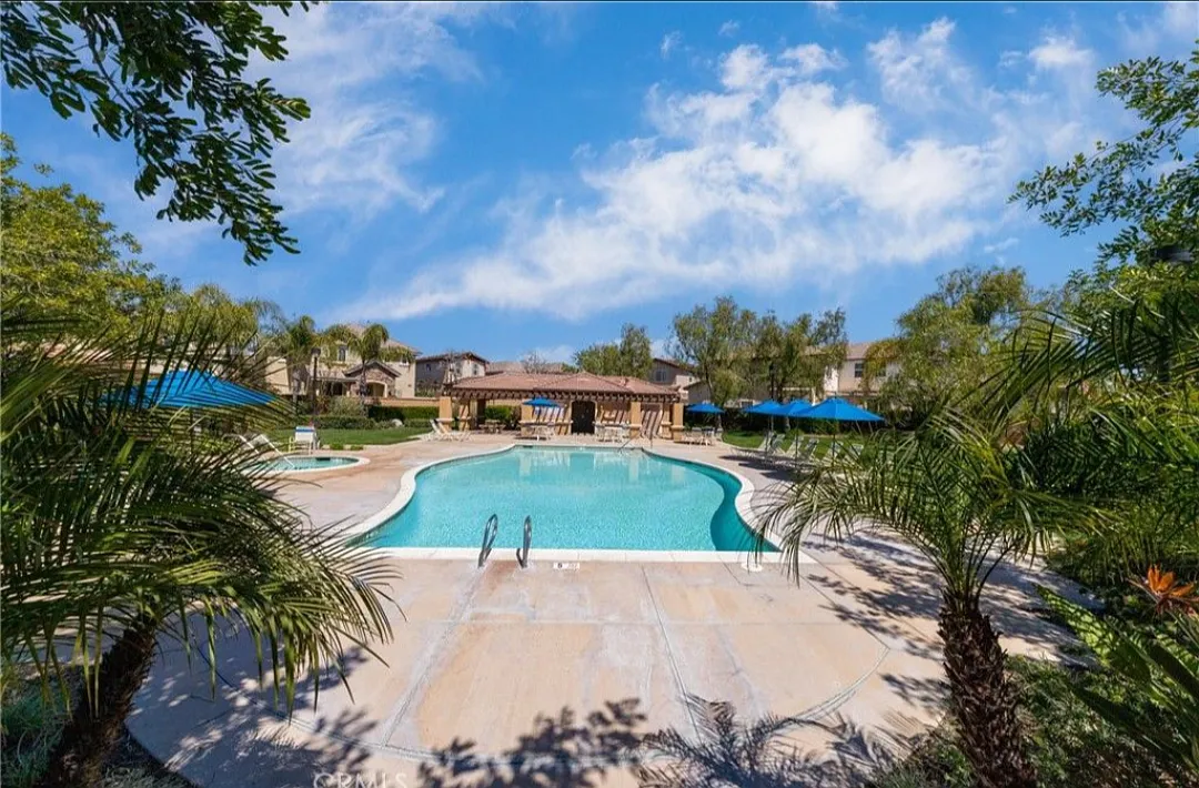 This picture shows the refreshing community pool and spa, with bathrooms and shade. - 29794 Tucana Pl