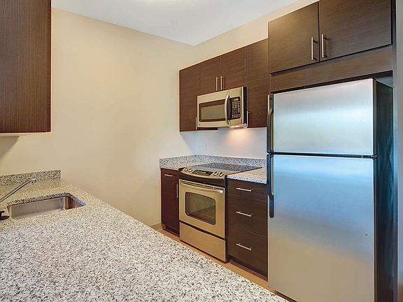 Kitchen with GE Clean Steel appliances and granite countertops
