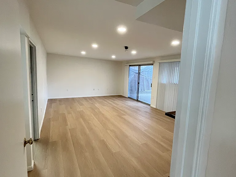 Very large family room that abuts the covered patio and has an entryway to the garage.