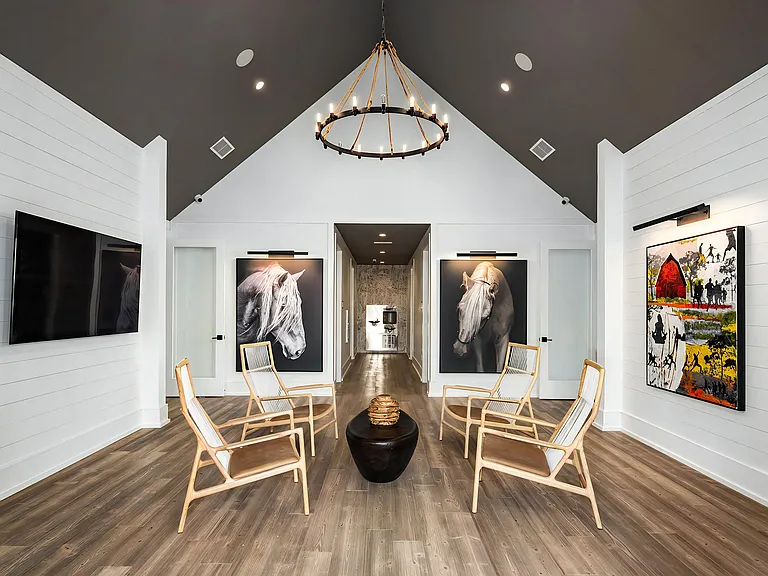 Bright Atrium Lounge with Vaulted Ceiling, Artistic Decor, and Wood Accents
