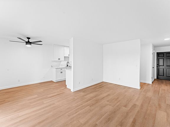 The expansive space is adorned with rich LVP floors that add a touch of sophistication and create a seamless flow throughout the home.
