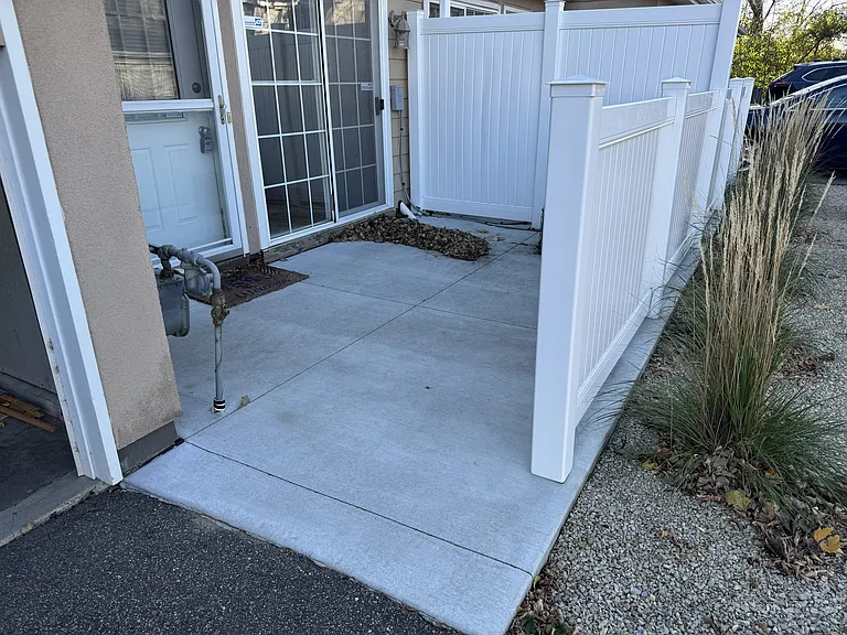 Fenced patio with walk-out sliding patio door