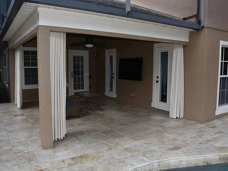 Large Covered and Screened Entertaining Area.