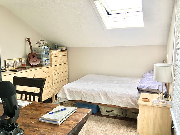 The room: All furniture will be different and there is now a built-in bookshelf spanning the whole short wall.