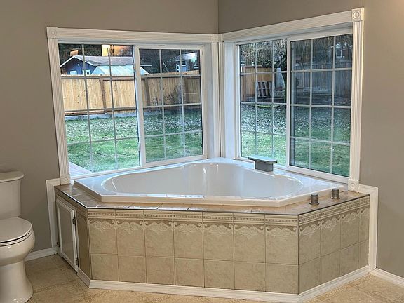 Jetted tub with waterfall faucet.