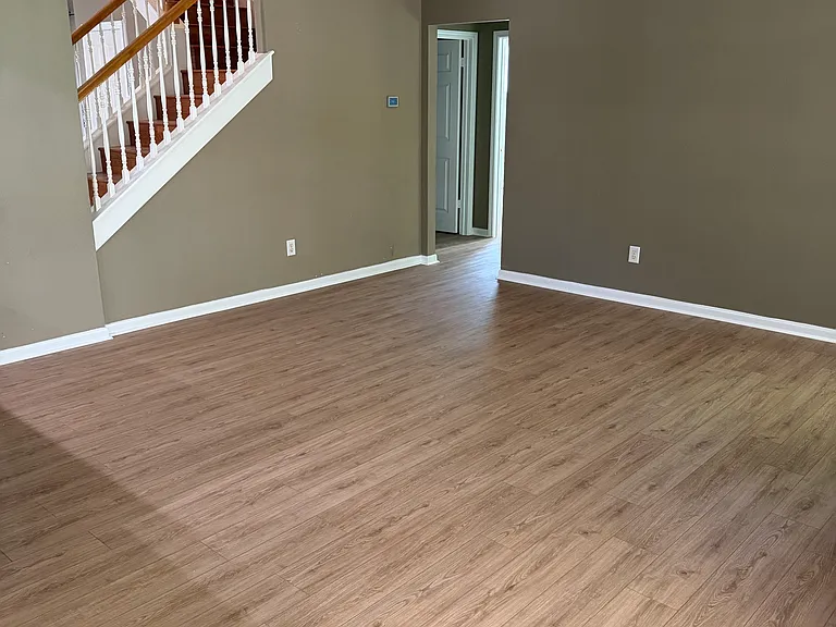 Main floor common space. Great for a living room. Door at back of room leads to Laundry Room, Main Floor Bedroom and Main Floor Bathroom.