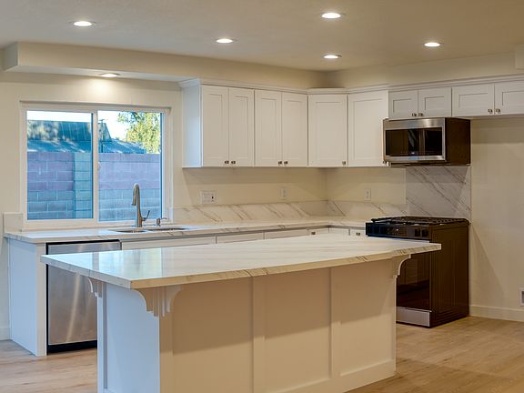 Standing in Dining Room area looking at Kitchen and down length of home.