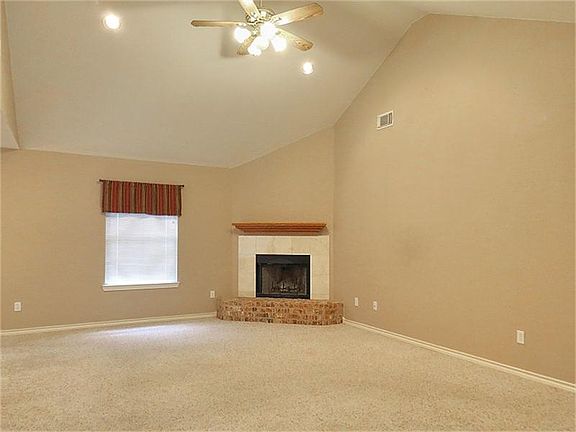 Soaring ceiling in living with tile surround fireplace!