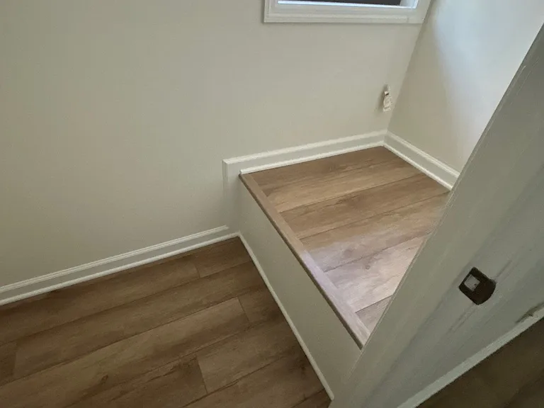 The walk-in closet also has a storage platform below a window.