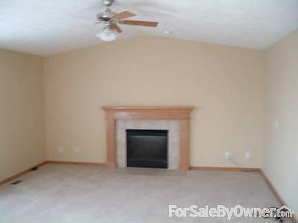 Family room with fireplace surrounded by tile and mantel. Wired for surround.