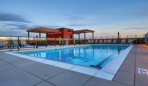 Hang out at the rooftop pool and social deck - Yorktown Apartment Homes