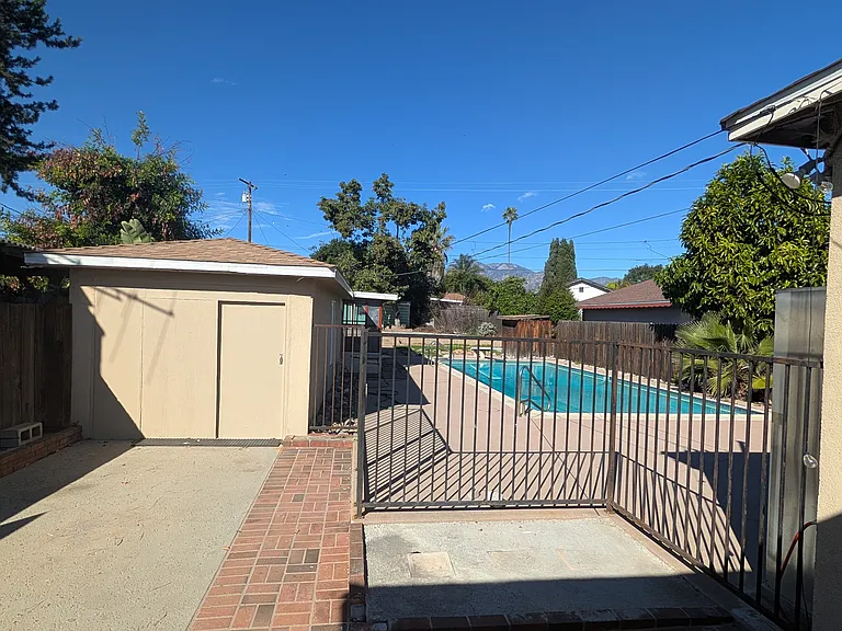 Garage, Pool & Large backyard with avocado tree.