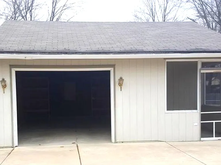 1 detached car garage with 150 sq ft storage space and small porch.