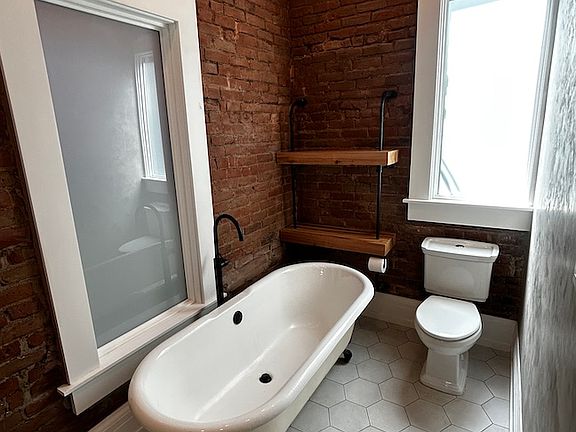 first floor bath with shelving and tinted windows