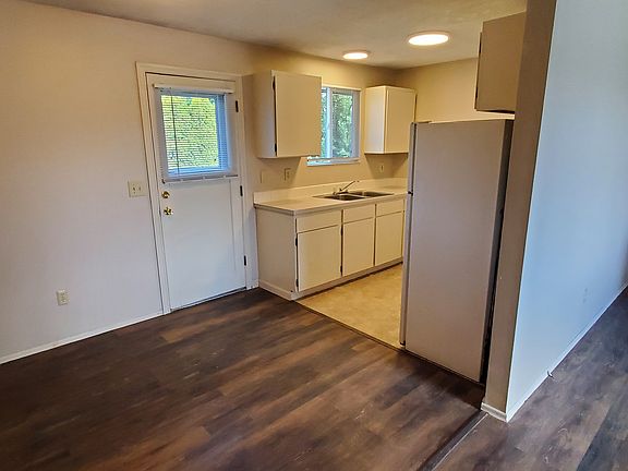 View of dining area, kitchen and hall