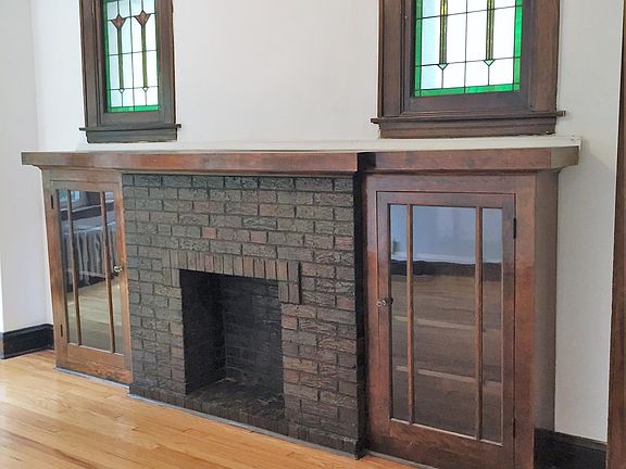 Decorative fireplacew with built ins and stained glass windo