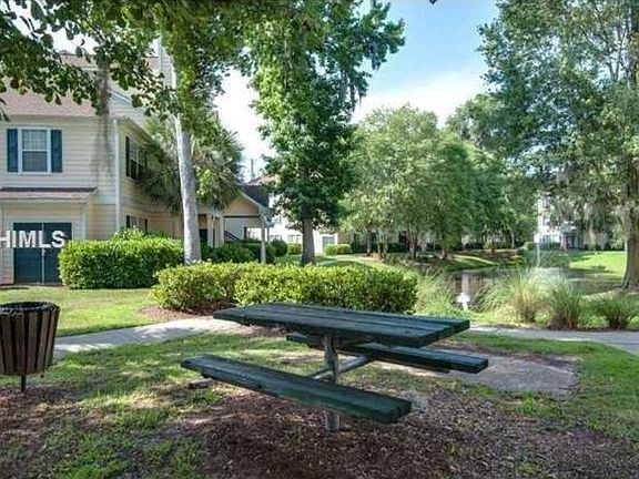 Lagoons, shrubbery, and mature trees grace the landscaping