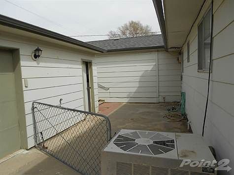 Patio area between garage and house.