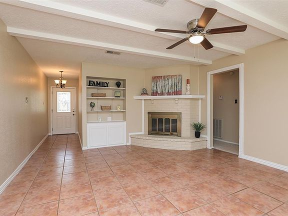 ENTRY & FAMILY ROOM - Neutral paint and tile flooring. Nice ceiling beams to add character to the room.