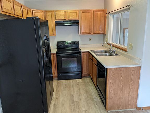 Kitchen with new flooring. Behind is a seating area for meals.