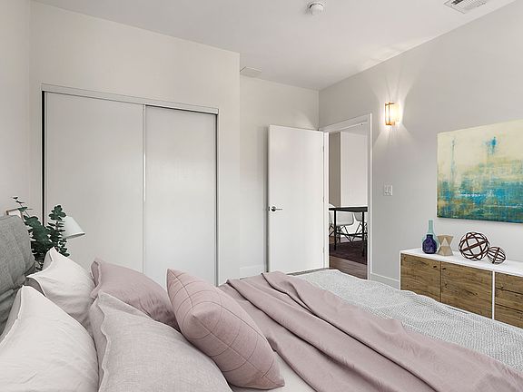 Carpeted bedroom with private closet.