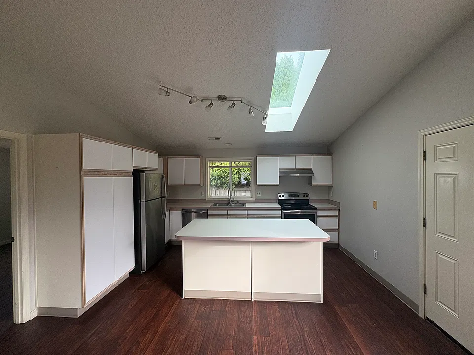 Vaulted kitchen open to the dining room and living room.