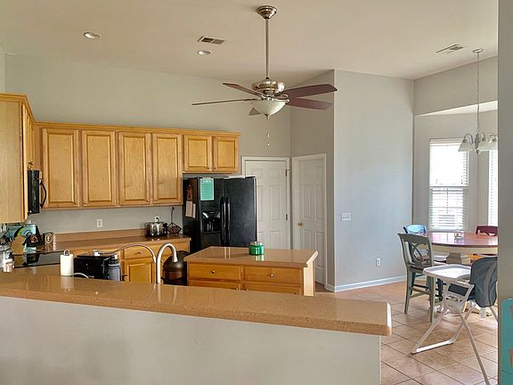 Lots of Cabinets in Kitchen with Corian Countertops, Ceramic Floors, Bay Window and Large Pantry