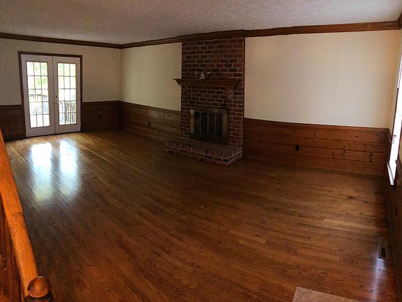 Den with wood burning fireplace