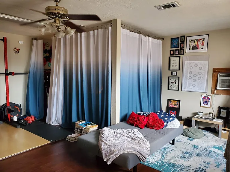 When the previous tenant furnished it, she set up a curtained off bedroom area.