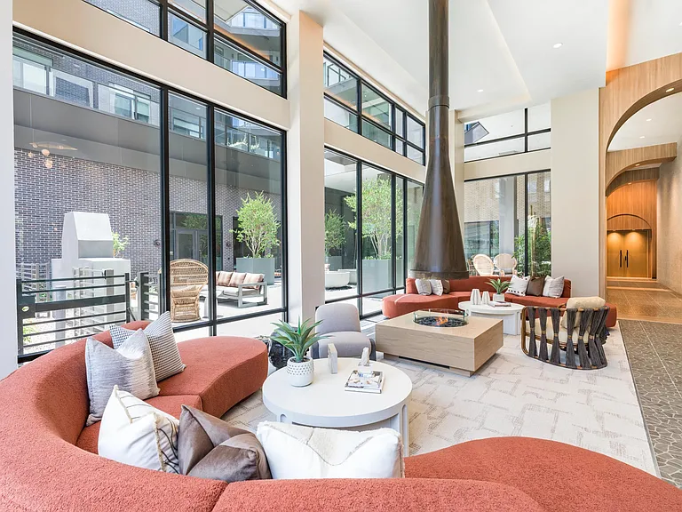 Stylish indoor and outdoor lounge spaces offer cozy spots to relax, complete with modern seating and warm natural light.